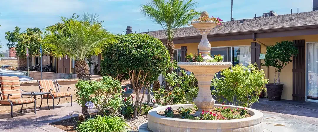 The back patio of the Huntington Valley facility showing a large a fountain and gardens