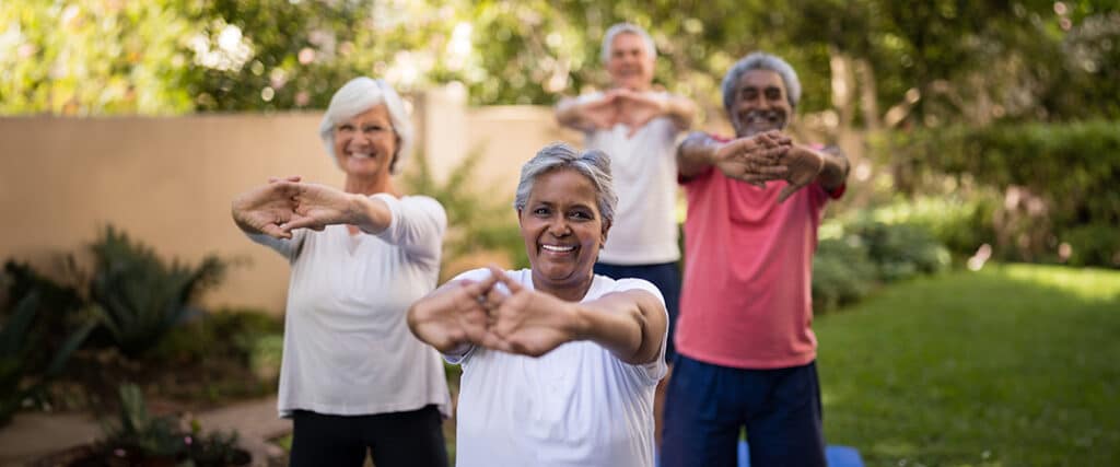 Seniors outside stretching on a sunny day