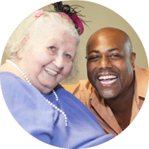 caregiver and elderly resident laughing and smiling